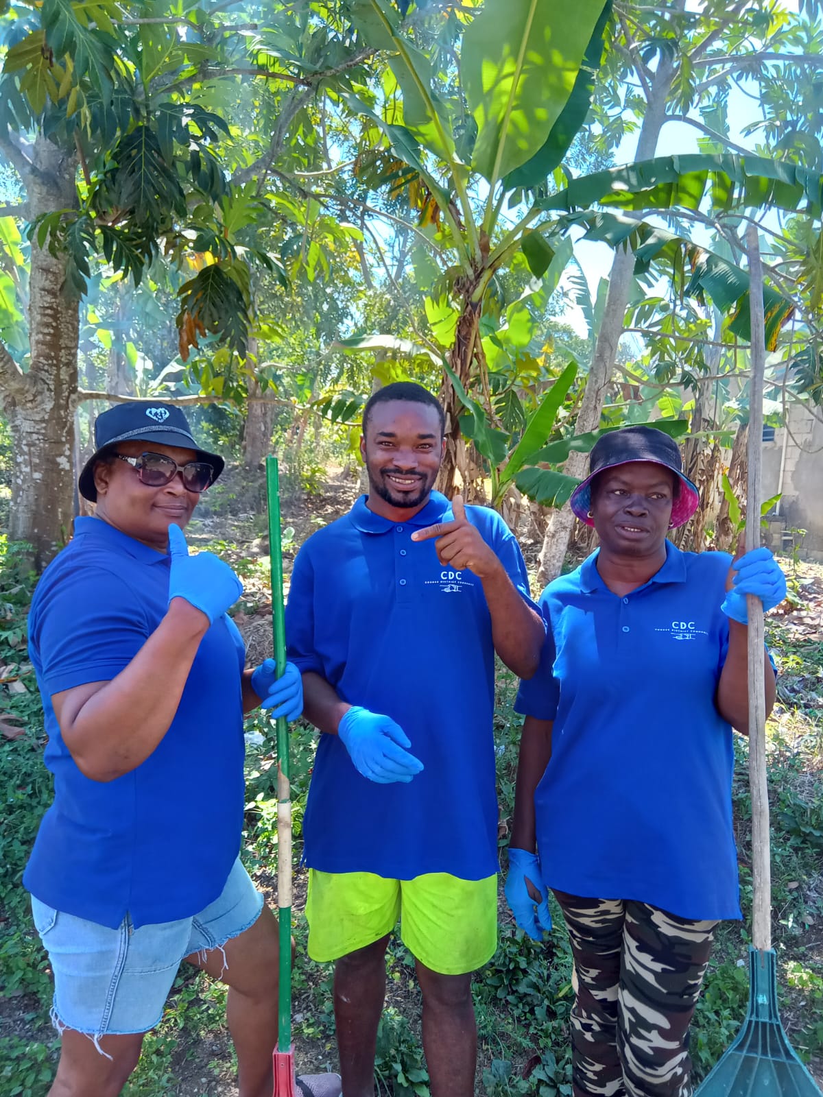 A group picture comprising of one man and two women, three members of the community group Friends & Families of Northern Clarendon, based in Jamaica.